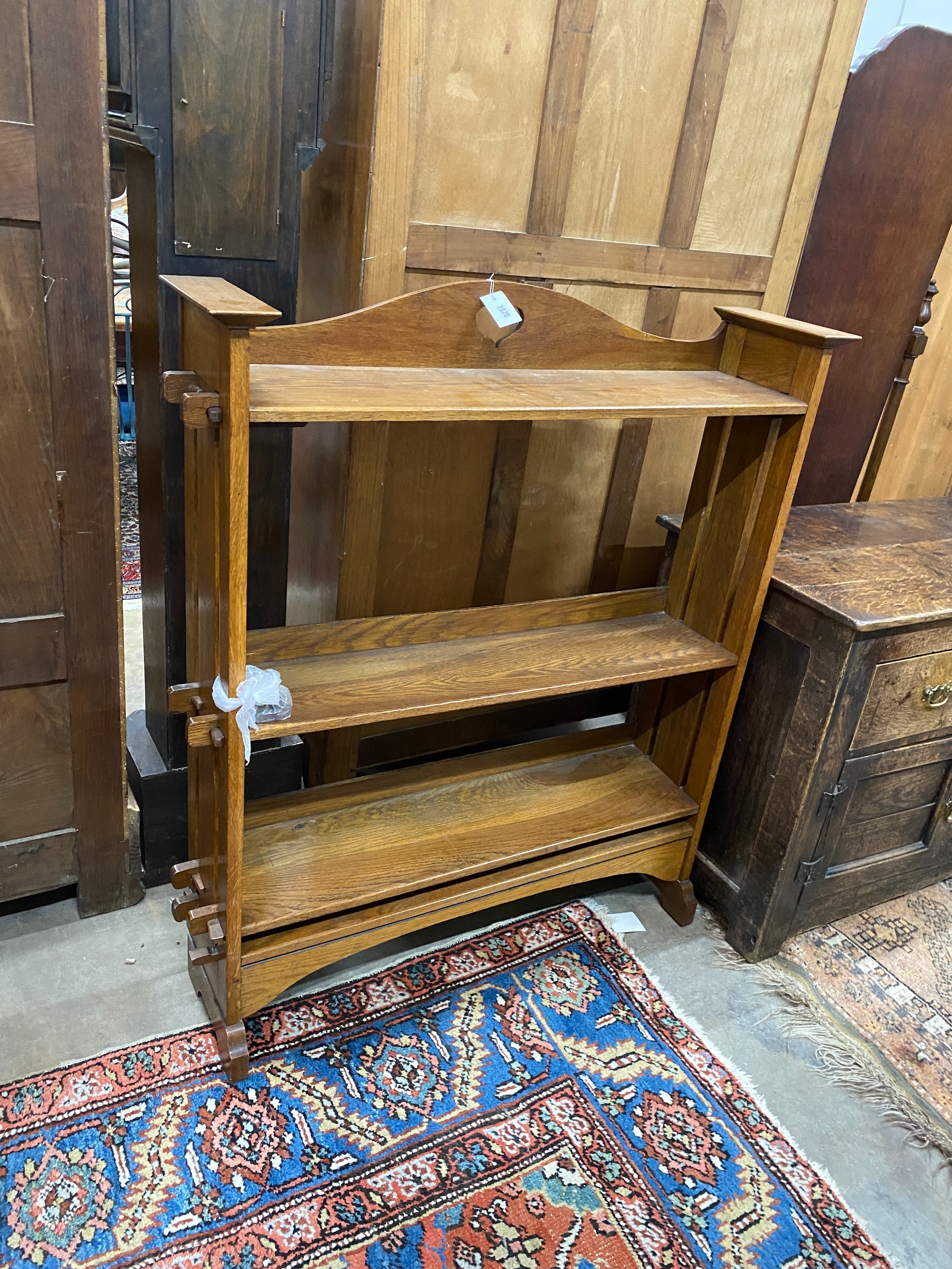 An Arts & Crafts oak open bookcase, length 100cm, depth 26cm, height 118cm